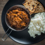 A Madras Curry in the UK has become synonymous with a fiercely hot curry and not much else, my version has more complex flavours but still with a punch of heat from chili and pepper.
