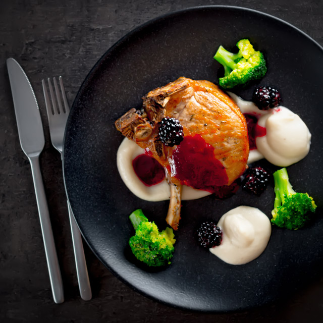 Pork Chops with Jerusalem Artichoke Puree Pork chops are served along side a silky Jerusalem artichoke puree with a cider and blackberry sauce on this perfect late summer early autumn dish.