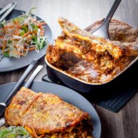 A classic baked lasagne is a thing of great beauty, unctuous rich beef ragu, a luxurious white sauce and layers of pasta with a cheesy topping.