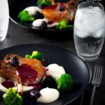 These Pork chops are slow baked to keep then lovely and tender they are served alongside a silky Jerusalem artichoke puree with a cider and blackberry sauce on this perfect late summer early autumn dish. #porkrecipes #porkchoprecipe