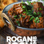 Portrait image of a lamb rogan josh curry served in a copper coated curry bowl with a naan bread with text