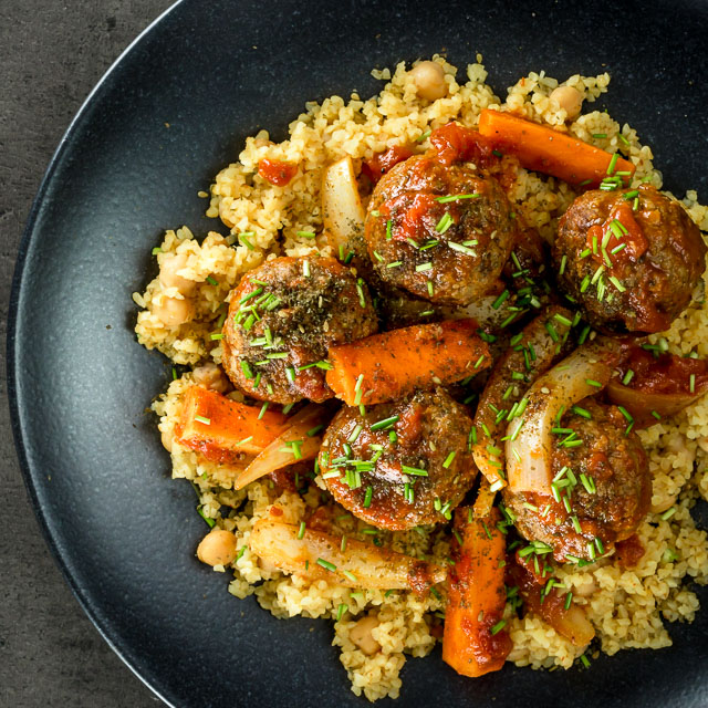Moroccan Beef Meatballs with Bulgar Wheat and Chickpeas The bed of Harissa spiked bulgar wheat and chickpeas is the perfect bed for these Moroccan inspired beef meatballs, a wonderful winter warmer!