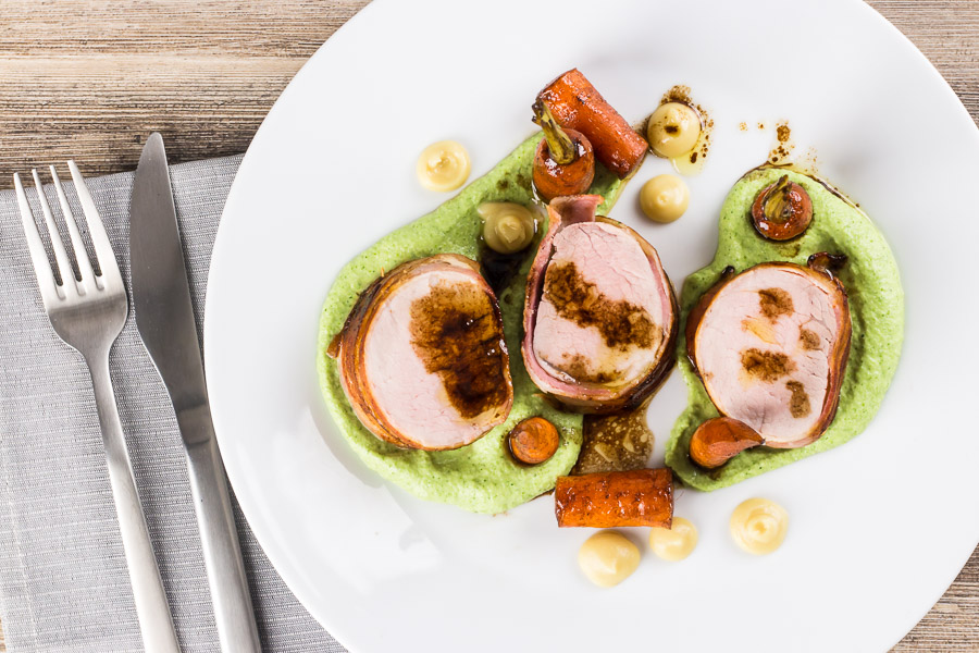 Bacon Wrapped Baked Pork Tenderloin With Balsamic Carrots Anything wrapped in bacon is awesome so this simple bacon wrapped baked pork tenderloin really owns it and the whole meal is more simple than it looks. All told this can be on your table in a shade under an hour.