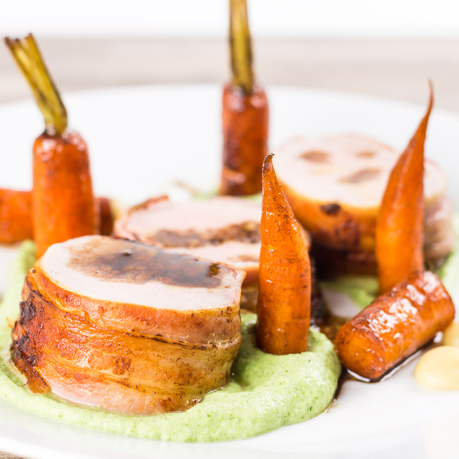 Bacon Wrapped Baked Pork Tenderloin With Balsamic Carrots Anything wrapped in bacon is awesome so this simple bacon wrapped baked pork tenderloin really owns it and the whole meal is more simple than it looks. All told this can be on your table in a shade under an hour.