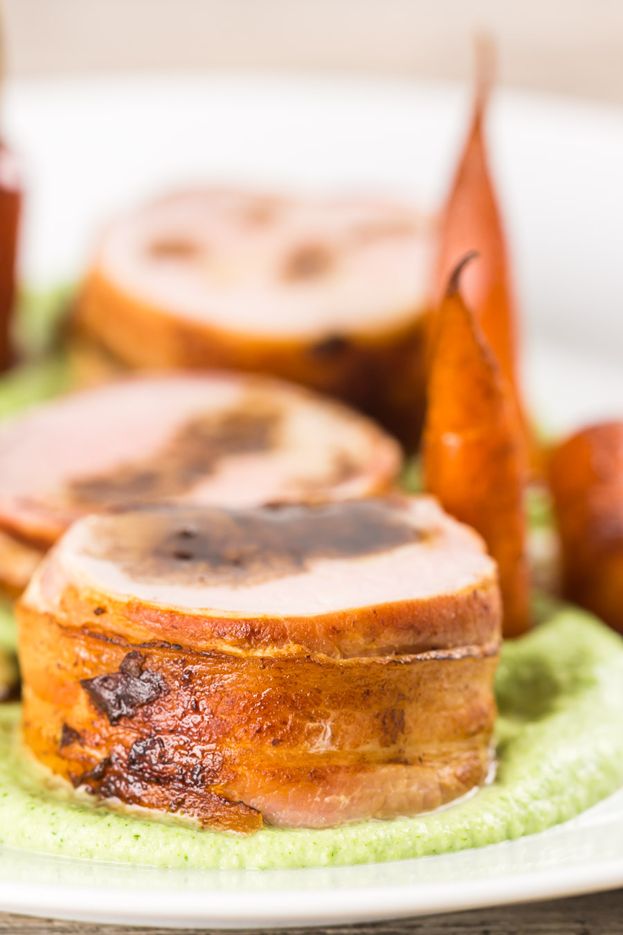 Bacon Wrapped Baked Pork Tenderloin With Balsamic Carrots Anything wrapped in bacon is awesome so this simple bacon wrapped baked pork tenderloin really owns it and the whole meal is more simple than it looks. All told this can be on your table in a shade under an hour.