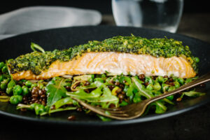 Baked salmon is a beautiful thing and this herb crust salmon is served with a vibrant green warm lentil salad and a simple but great balsamic dressing.