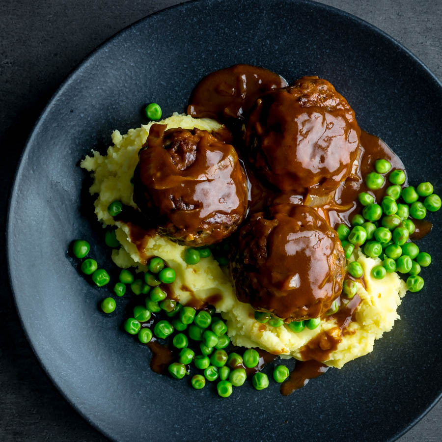 Faggots and Mash with Peas Faggots and Mash were the meatballs I grew up with a staple of the Midlands in the UK have sadly fallen out of favour but these old skool classics are still my favourite!