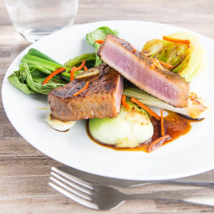 This glorious honey and soy glazed tuna steak is pimped up with a bit of chili and seared rather than cooked, it is served with some garlic braised pak choi and spring onions.