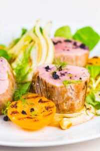 Roast pork tenderloin is the perfect 'quick cook' piece of meat, beautifully tender when cooked pink and served here with gin braised fennel and seared apricots.