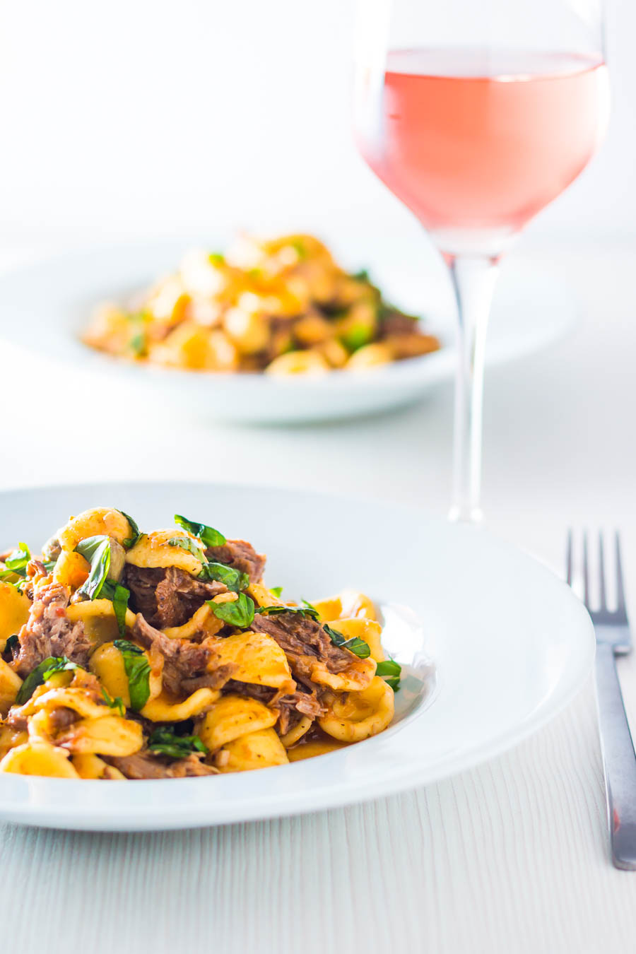 Pork Ragu that tastes like it has been slow cooked for 24 hours in an hour or so thanks to the Instant Pot served with hearty Orecchiette Pasta.