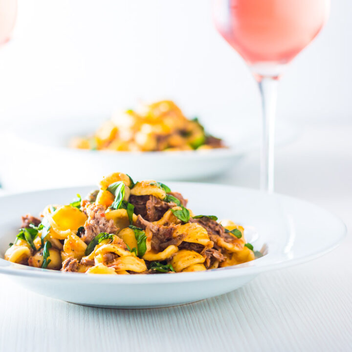 Pork Ragu that tastes like it has been slow cooked for 24 hours in an hour or so thanks to the Instant Pot served with hearty Orecchiette Pasta.