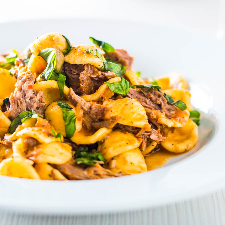 Pork Ragu that tastes like it has been slow cooked for 24 hours in an hour or so thanks to the Instant Pot served with hearty Orecchiette Pasta.