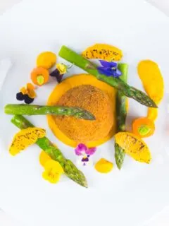 These confit duck leg bonbons are at the centre of a surprisingly light and wonderfully fancy meal featuring an orange and cumin puree and asparagus.