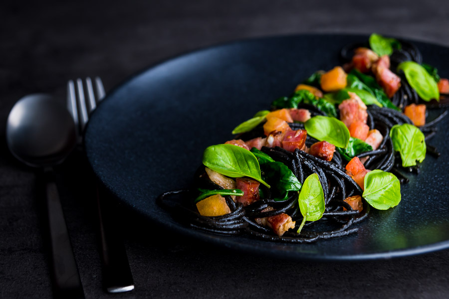Squid Ink Pasta with Bacon Spinach and Capers Squid ink pasta is a great way of adding extra drama and flavour into simple pasta dishes, this great recipe comes together in around 20 minutes and is always a winner.