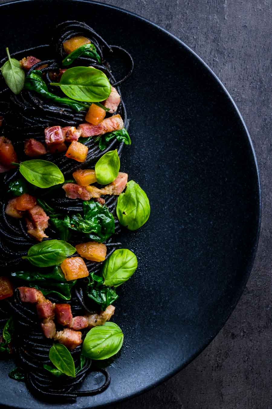 Squid Ink Pasta with Bacon Spinach and Capers Squid ink pasta is a great way of adding extra drama and flavour into simple pasta dishes, this great recipe comes together in around 20 minutes and is always a winner.