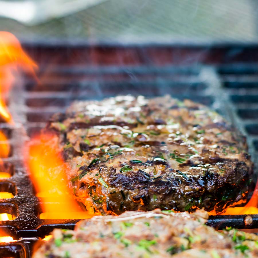 Venison Burger With Peaches And Blue Cheese-1 You can't beat a good grilled burger, but there is life beyond beef. This venison burger is topped with gin cooked peaches and blue cheese!