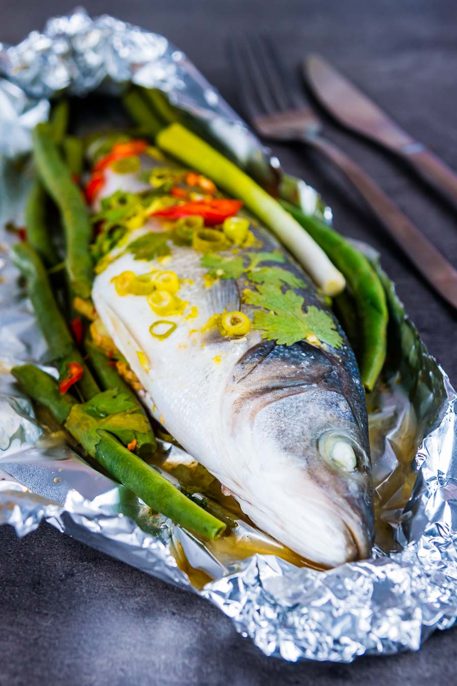 Asian Fish En Papillote (Sea Bass) This Asian Fish En Papillote features a classic French technique with bright and vibrant Asian flavours, you cannot beat a whole sea bass cooked on the bone