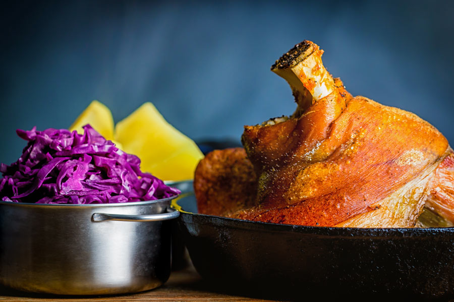 Crispy Beer Roasted Pork Knuckle With Red Cabbage Popular across all of central Europe my version of beer roasted pork knuckle has definite Hungarian leanings with dark beer and caraway seeds.