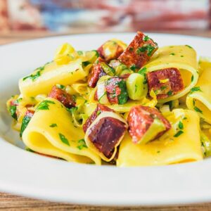 Close up square crop of a salami and leek pasta recipe