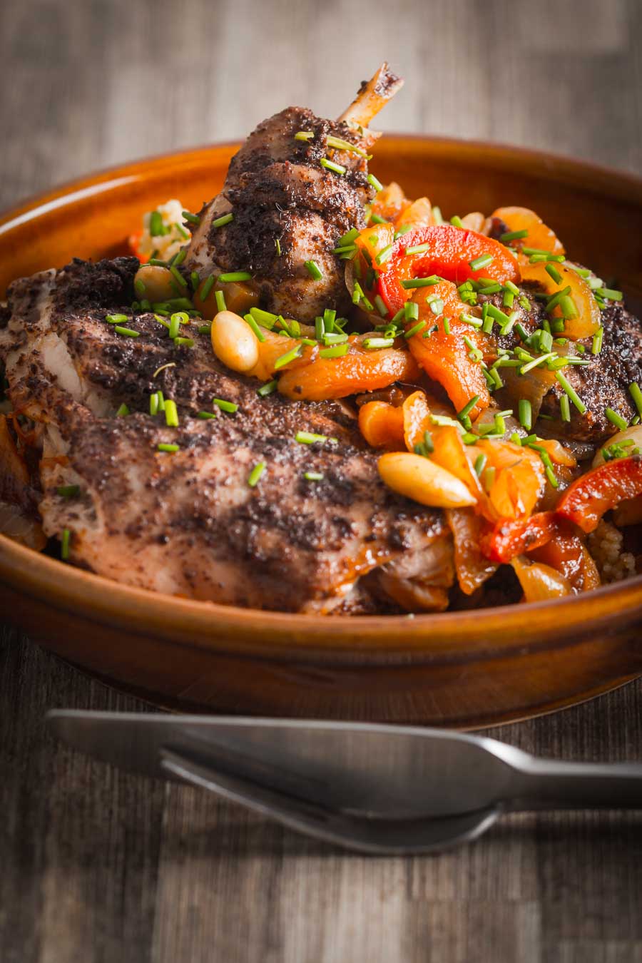 A bowl filled with meat and root vegetables.