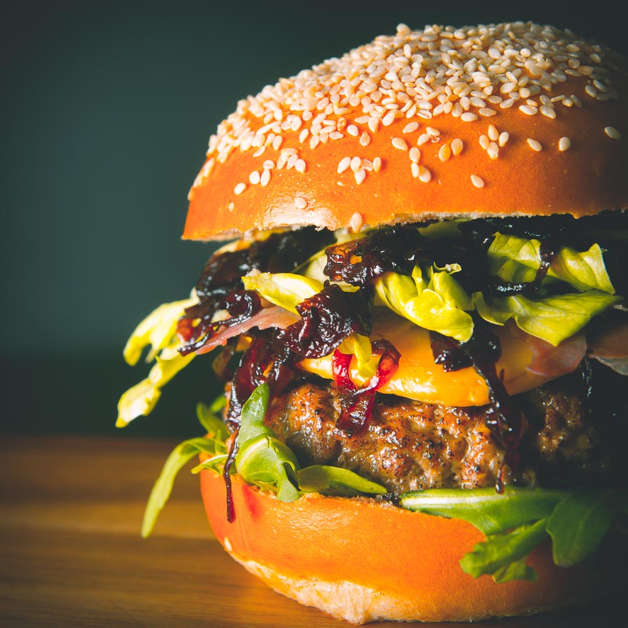 This Veal Burger is my idea of a real indulgent treat, a ground rose veal patty is accompanied by nutty Gouda cheese, Parma Ham and sticky cooked Onions.