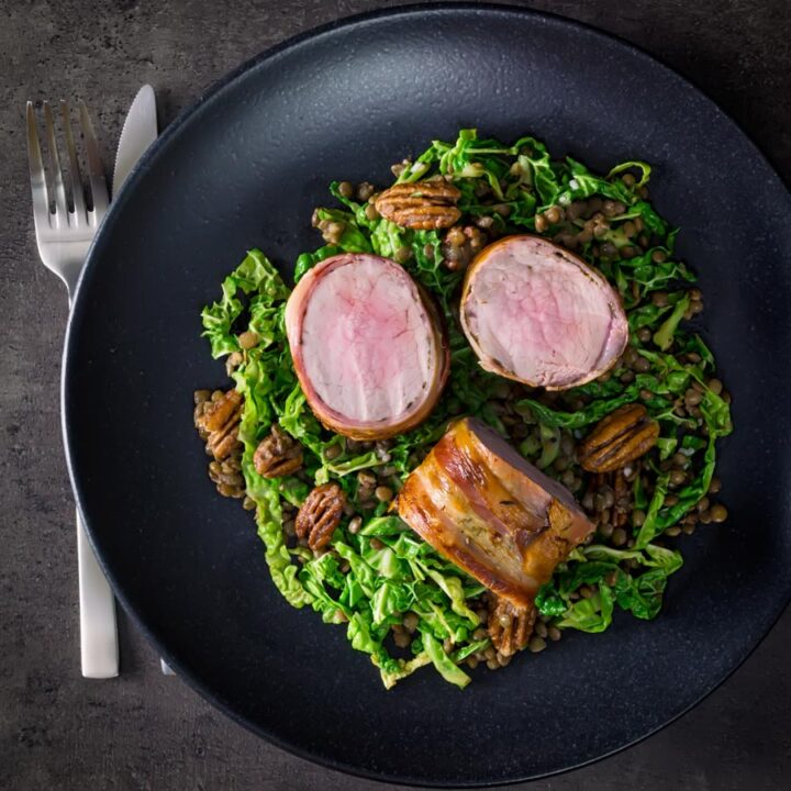 This simple bacon wrapped pork tenderloin recipe is served with a fantastic lentil, pecan nut and cabbage side dish dressed with a mustard dressing.