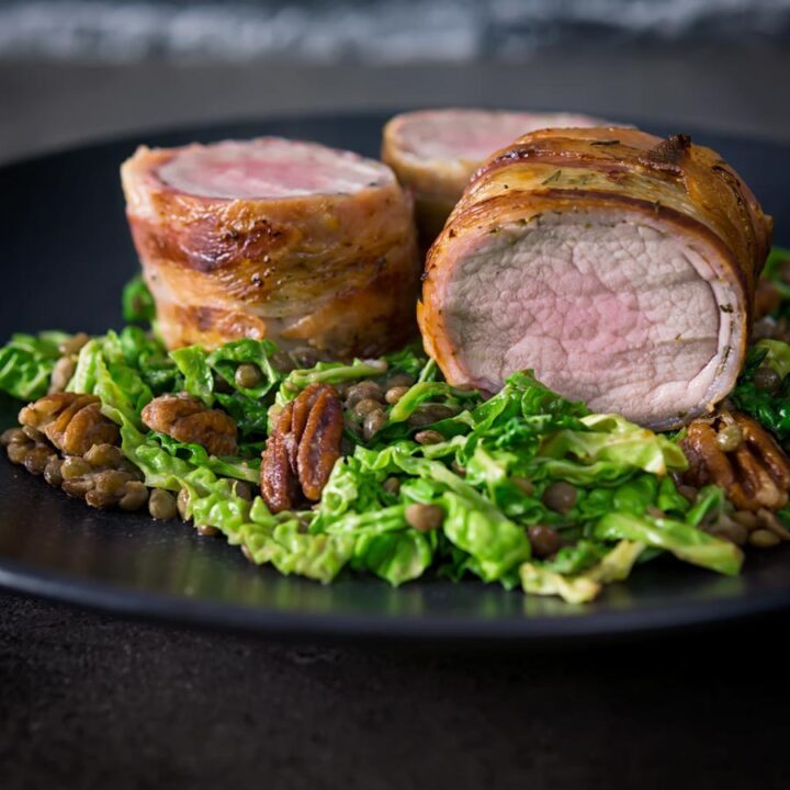 This simple bacon wrapped pork tenderloin recipe is served with a fantastic lentil, pecan nut and cabbage side dish dressed with a mustard dressing.