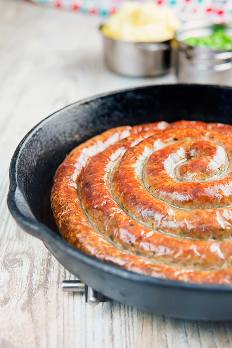 A glorious made from scratch coiled Cumberland Sausage is the star of this very British bangers and mash recipe that also has a kick ass onion gravy!