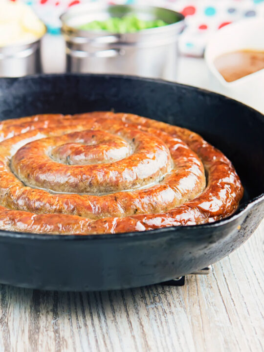 A glorious made from scratch coiled Cumberland Sausage is the star of this very British bangers and mash recipe that also has a kick ass onion gravy!