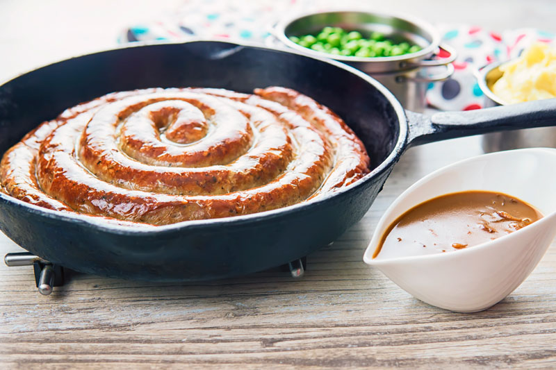 A glorious made from scratch coiled Cumberland Sausage is the star of this very British bangers and mash recipe that also has a kick ass onion gravy!