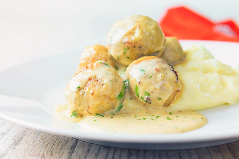Honey and mustard chicken meatballs served with mashed potatoes.