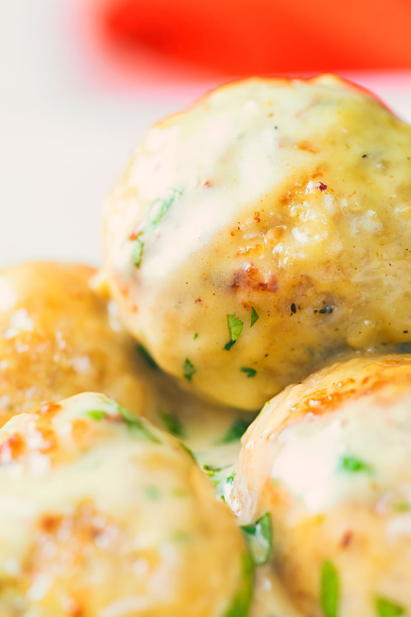 Close up image of chicken meatballs in a creamy honey and mustard sauce