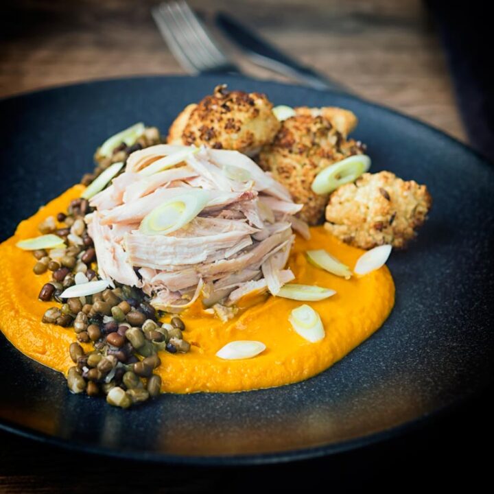 These slow-cooked rabbit legs are poached in an Indian flavoured broth and served with a spicy carrot puree, roasted cauliflower, and mung beans.