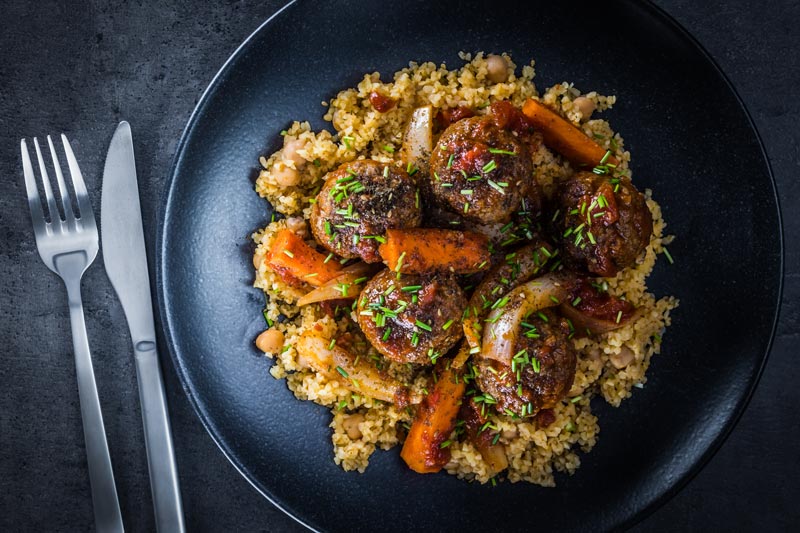 The bed of Harissa spiked bulgur wheat and chickpeas is the perfect bed for these Moroccan inspired beef meatballs, a wonderful winter warmer!
