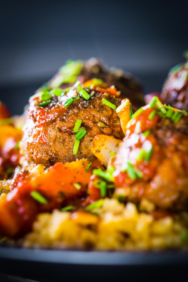 The bed of Harissa spiked bulgur wheat and chickpeas is the perfect bed for these Moroccan inspired beef meatballs, a wonderful winter warmer!