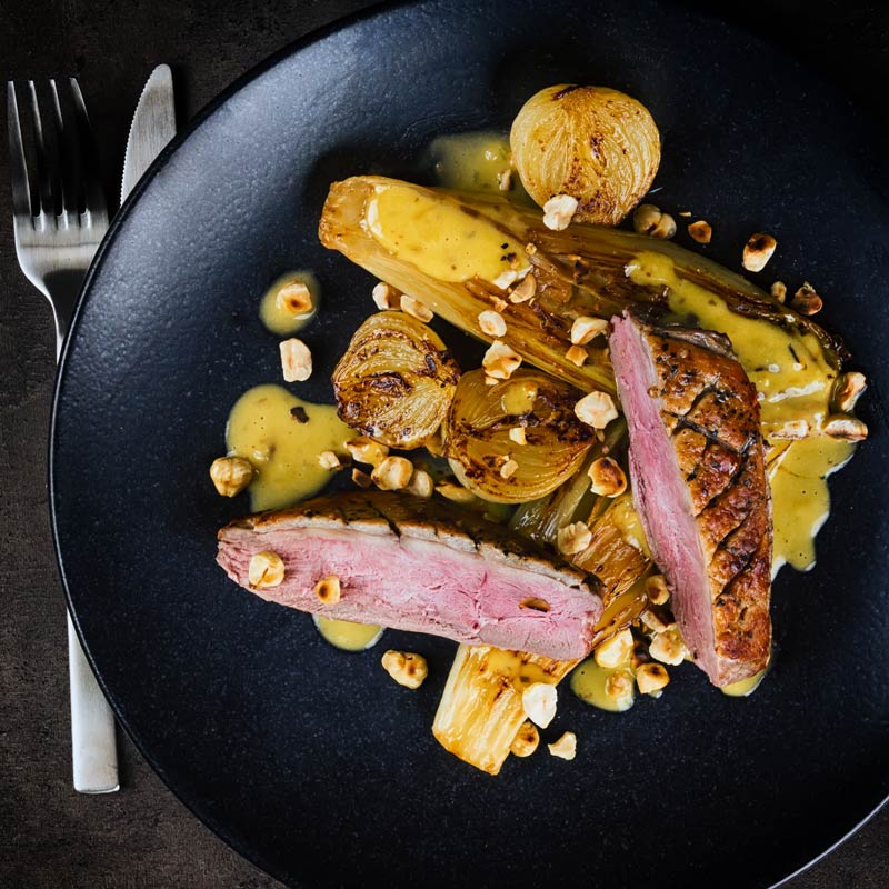 Endive may not be the first on the list of many peoples favourite vegetables, but it should be and it is perfect alongside this pan fried duck breast that utilises the cold pan method and is bundled a sexy anchovy sauce and it take less than an hour from start to finish. #endivesbraises #duckbreastrecipes #duckmaincourse #hazelnutsrecipes