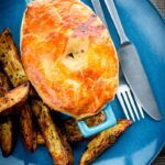 This easy Chicken and Mushroom Pie recipe is an all-time classic British pie, this one takes the pot pie approach using shop bought puff pastry for a quick and simple midweek dinner.