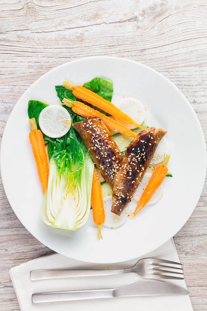 Blow torched Smoked mackerel fillets featuring in a smoked mackerel salad with pickled carrots, radish and blanched bok choi.