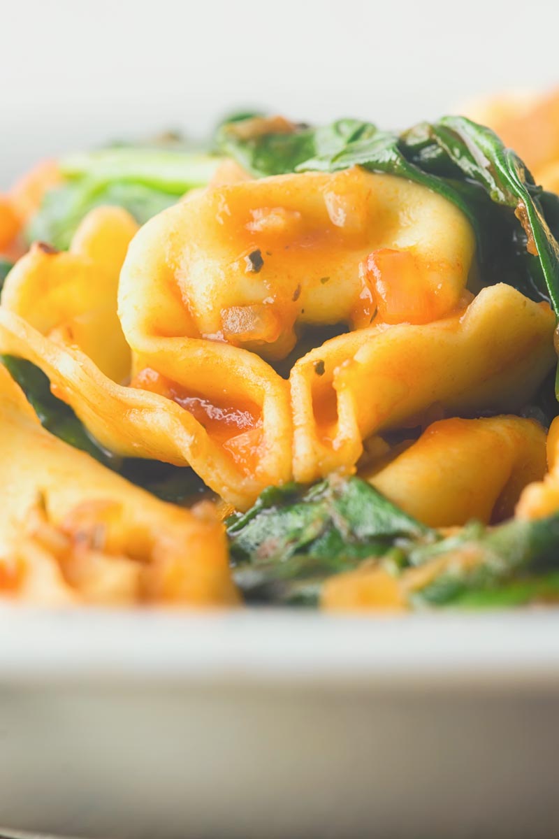 This tortellini soup is a hearty main course style soup that is crazy quick to make, a perfect midweek pantry "lifesaver" full of great flavours! I say quick to make it takes only 30 minutes for cupboard to bowl!