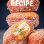 Portrait Image of cinnamon sugar coated donuts with a bite out of one cooked from a basic donut recipe with text