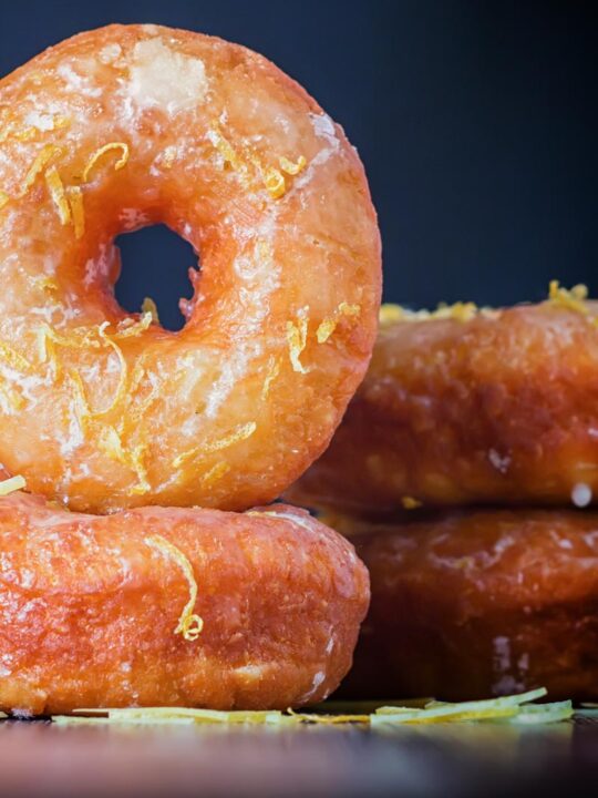Portrait Image of lemon glazed ring donuts cooked from a basic donut recipe