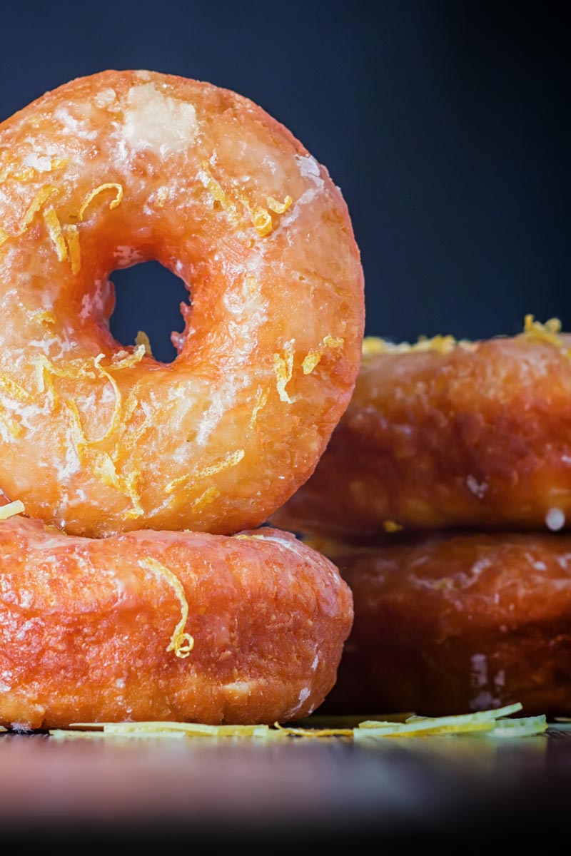 Portrait Image of lemon glazed ring donuts cooked from a basic donut recipe