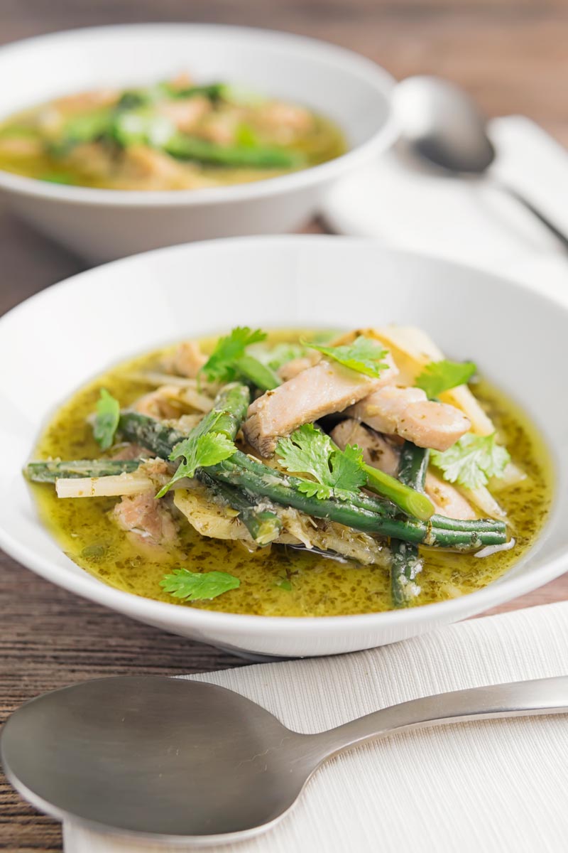 Portrait image of Thai Chicken Curry featuring beans and bamboo shoots served in two white bowls