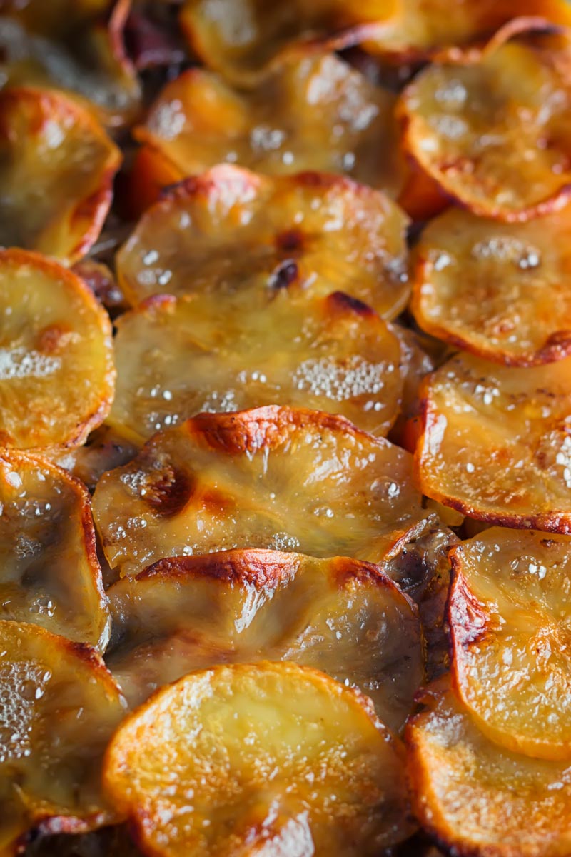 Portrait close up image of a lamb hotpot pie lid of sliced golden potatoes