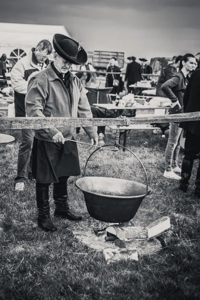 Black and white image of traditional hungarian cooking over an open fire