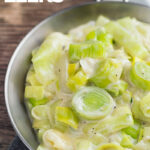 Portrait image of classic creamed leeks served in a pan with text overlay