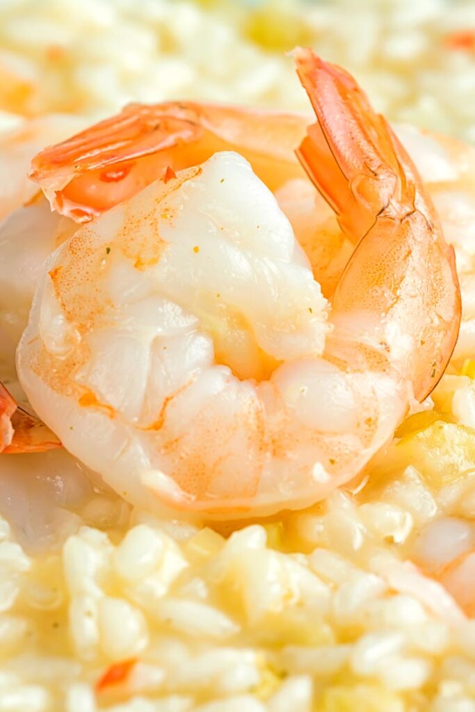 Close up portrait image king prawns served on a lemon and chilli risotto