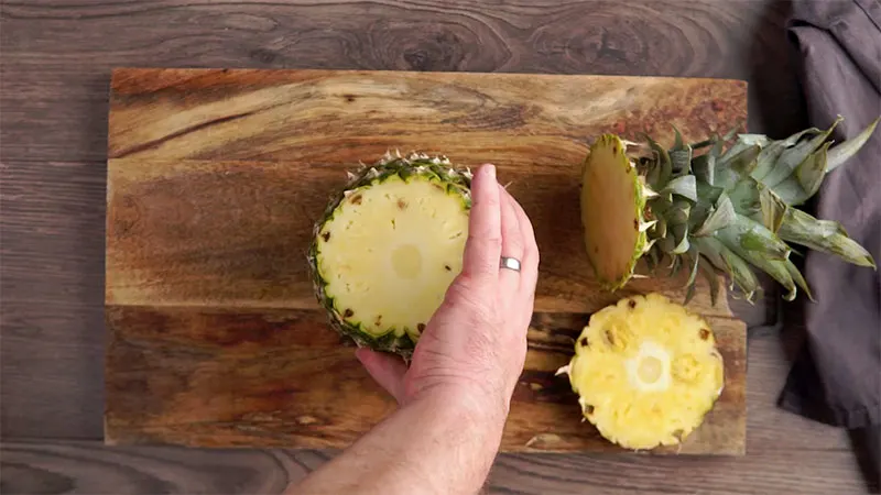 Step 2 in how to prepare a pineapple, stand on end