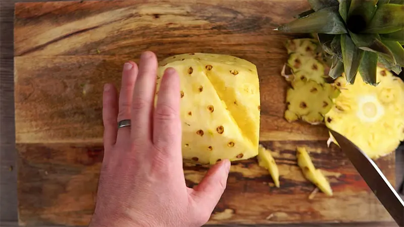 Step 5 in how to prepare a pineapple, remove eyes with second side of v shaped cut