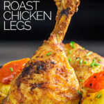 Portrait image of Indian spiced roast chicken legs served with Bombay potatoes on a white plate with a text overlay